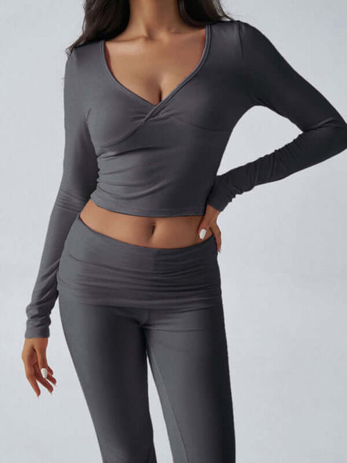 womens yoga activewear set featuring a slim fit long sleeve top and matching pants in a sleek gray design.