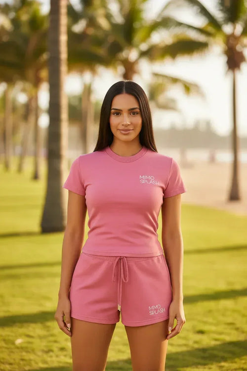 MIMOSPLASH Women's Pink Crop Top and Shorts Set worn by a model in a sunny outdoor setting, showcasing stylish activewear.