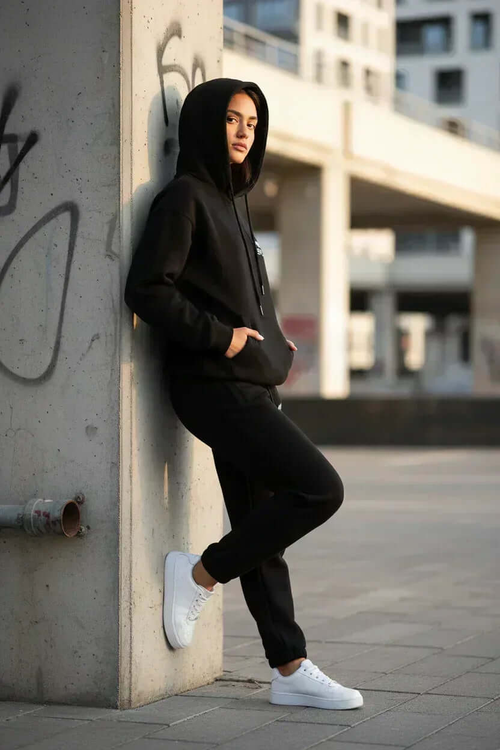 MIMOSPLASH Women's black hoodie jogger tracksuit set styled against an urban backdrop.
